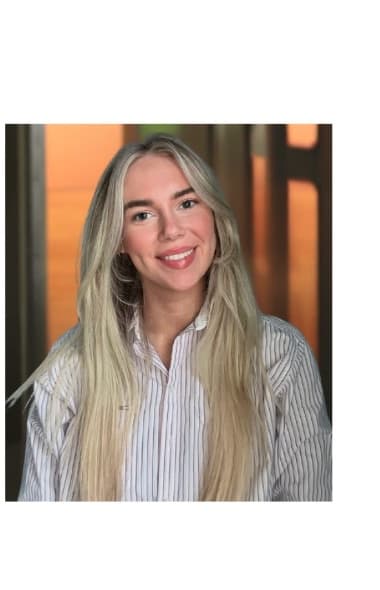 Community host smiling in a striped shirt