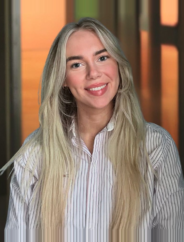 Community host smiling in a striped shirt